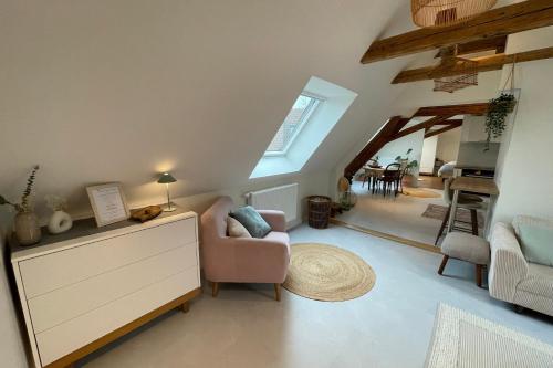 a living room with a couch and a chair at La Girouette in the heart of a farmhouse in Mittelhausbergen