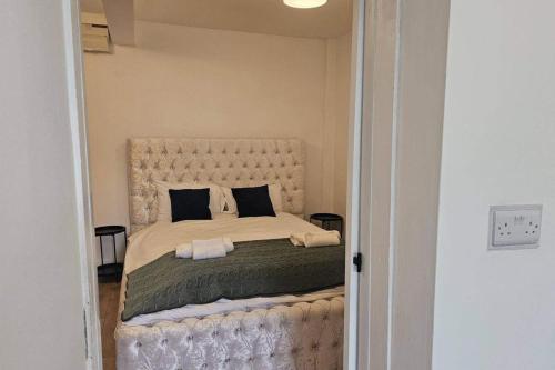 a bedroom with a large bed with two pillows at Studio - Sleeps 2 - Parking - WiFi in Bridgend