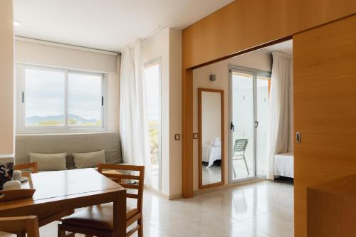 a dining room with a table and a room with a bedroom at Moon Dreams Atlantic in Es Cana