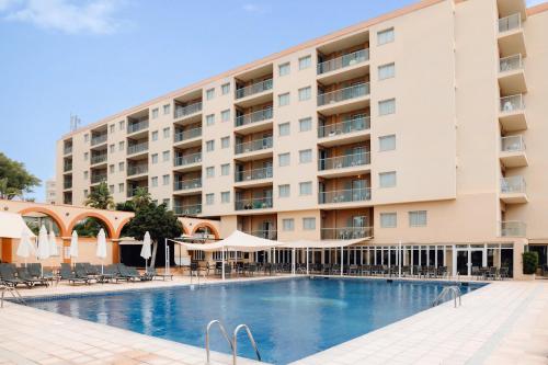 a hotel with a swimming pool in front of a building at Moon Dreams Atlantic in Es Cana