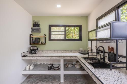 a kitchen with a sink and a counter top at Coconut WayWay Paradise Retreat by Sea N' Rent in Hinkong