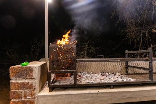 a fire pit with a bunch of rocks in it at Farmco Marloth Park in Marloth Park