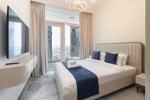 a bedroom with a bed and a large window at Free housekeeping visits during your stay - StayShort - Business Bay for 4 people with City Views in Dubai