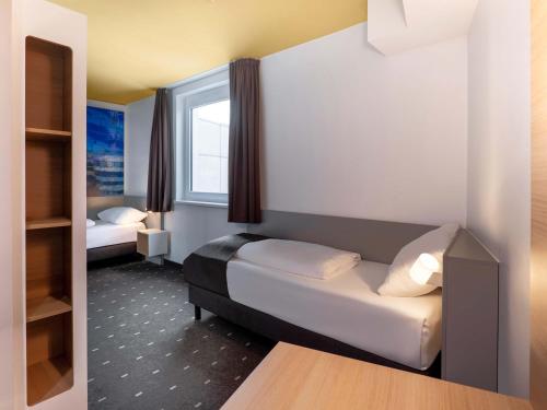 Ένα ή περισσότερα κρεβάτια σε δωμάτιο στο B&B Hotel Stuttgart-Airport/Messe