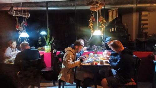a group of people sitting at a table in a restaurant at ECO ART Best view Machu Picchu in Machu Picchu