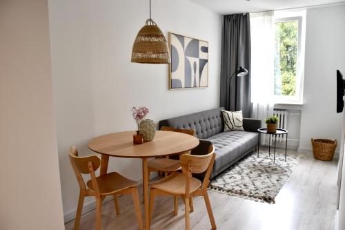 a living room with a table and a couch at Apartament Loft Centrum in Częstochowa