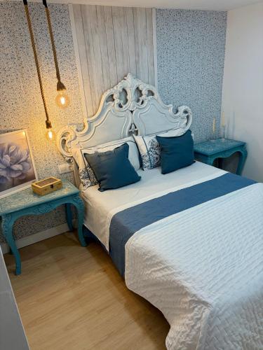 a bedroom with a large bed and two tables at Torres de la Catedral in Jaén