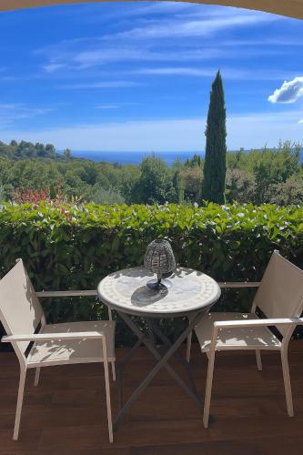 a table and two chairs on a patio at Les Hauts de la Riviera in Cabris
