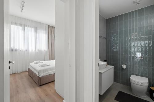 a bathroom with a bed and a toilet and a sink at Artemis 302 - Seaside Stories in Livadhia