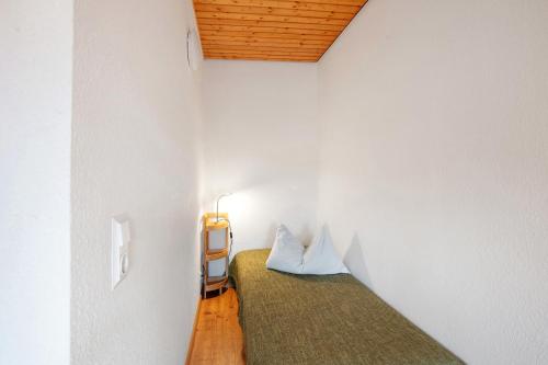 a small bedroom with a bed with two pillows at Ferienwohnungen Kehrwieder in Todtnauberg