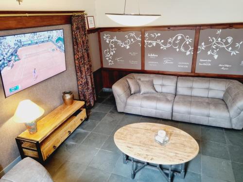 a living room with a couch and a table at Gîte des Roches in Cugnon