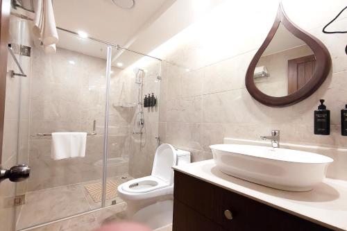 a bathroom with a sink and a toilet and a shower at Gangotri - A Divine River Retreat in Varanasi
