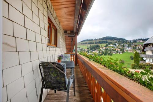 a balcony with a table and chairs on a building at Ferienwohnungen Kehrwieder in Todtnauberg