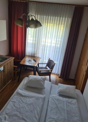 a hotel room with a bed and a table and a dining room at HOTEL Jerolitsch in Krumpendorf am Wörthersee