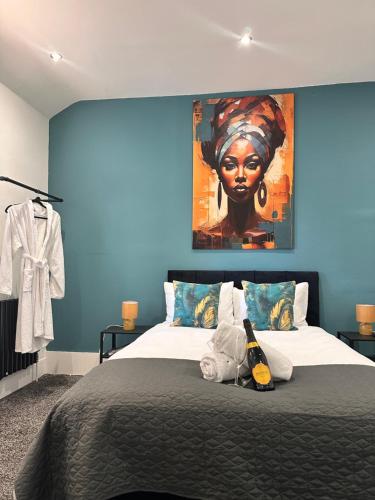 a bedroom with a bed with a painting on the wall at House in Tyneside Perfect for Travelers, Groups & Contractors Free Parking in Hebburn-on-Tyne