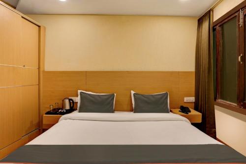 a bedroom with a large bed in a room at Collection O Dehradun Central Formerly Hotel Orange Residency in Dehradun