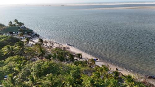 an aerial view of a beach with palm trees and the ocean at Casa Monan, Atins beach in Atins