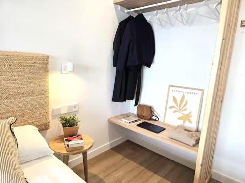 a room with a bed and a table with a bed gmaxwell gmaxwell gmaxwell at Playa Sardinero Little Homes 6 in Santander