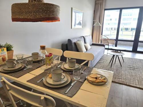 a living room with a table with plates of food on it at Playa Sardinero Little Homes 6 in Santander
