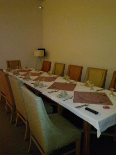 a long table with chairs and a white table cloth at The Enterprise in Karachi