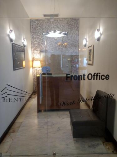 a room with a front office sign on the wall at The Enterprise in Karachi