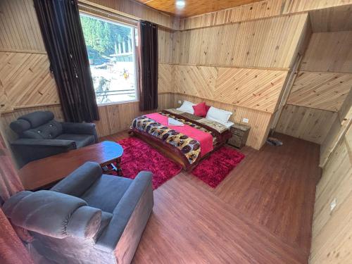 an overhead view of a bedroom with a bed and a couch at River Era by Naavagat in Jibhi