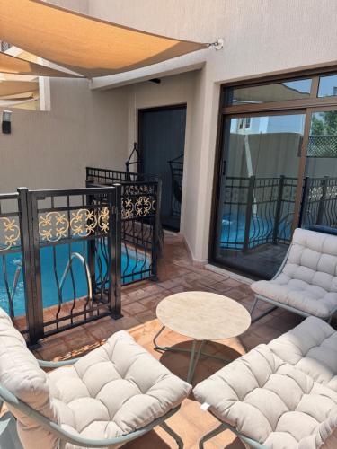 a patio with two couches and a table on a balcony at شاليه اللؤلؤة للعائلات فقط in Dammam