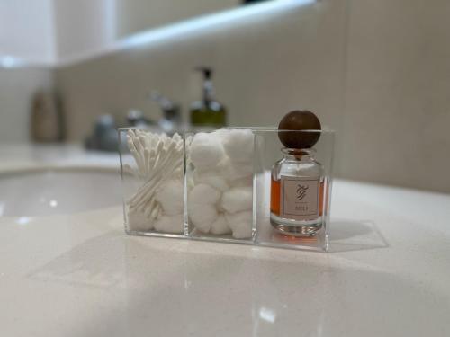 a bottle of perfume sitting on top of a counter at By The Beach - Prime location in Sarūq