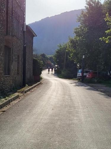 an empty street with people walking down the road at Charming rustic house - near river and forest in La Cellera de Ter