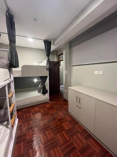 a bedroom with a bunk bed and a wooden floor at Checkpoint KTM - Boutique Urban Hostel in Kathmandu