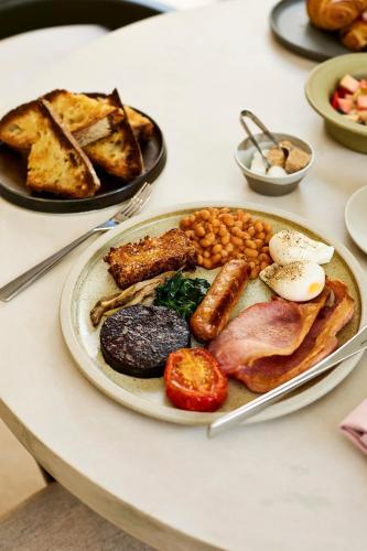 a plate of breakfast food on a table at House of George W Davies in Broadway