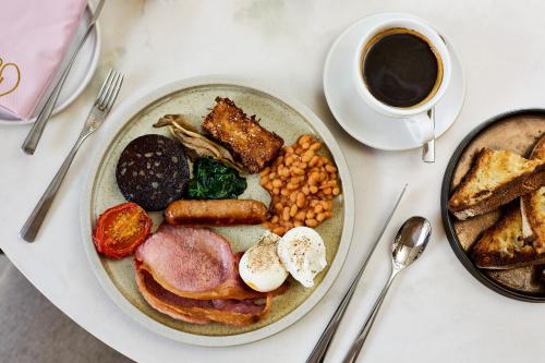 a plate of breakfast food with a cup of coffee at House of George W Davies in Broadway