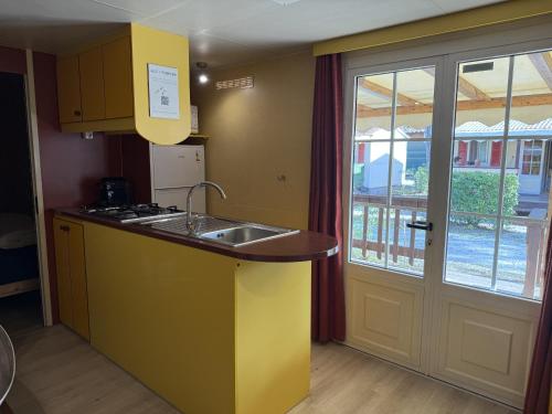 a kitchen with a sink and a counter top at Camping Paradiso - Aranciona 7 in Viareggio