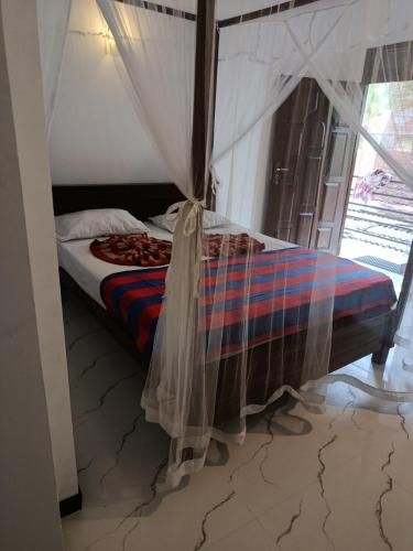 Ένα ή περισσότερα κρεβάτια σε δωμάτιο στο Villa Sunimal