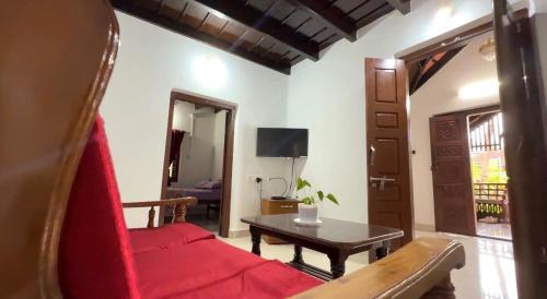 a living room with a red couch and a table at Aavasa Blu in Ullāl