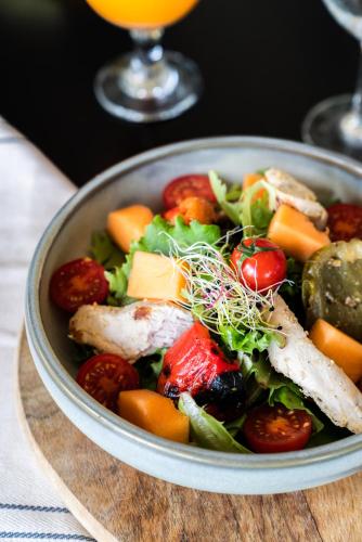 a bowl of salad with meat and vegetables on a table at Mercure Orléans Portes de Sologne in Ardon