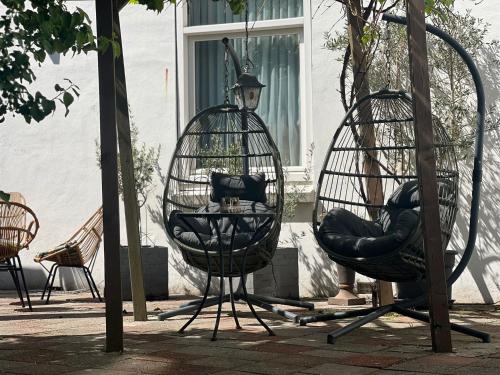 a couple of swings in front of a building at City2Beach Hotel in Vlissingen