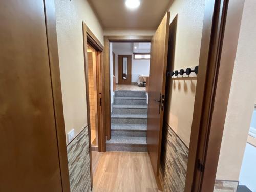 a hallway with stairs in a house at Mar de Nubes Piornal 1 in Piornal