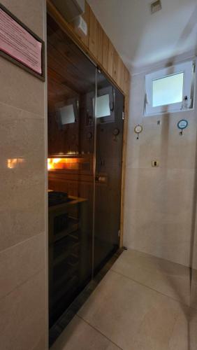 a kitchen with a glass door in a room at Vila MP Banstol 4*- Brdež do, Fruška gora in Inđija