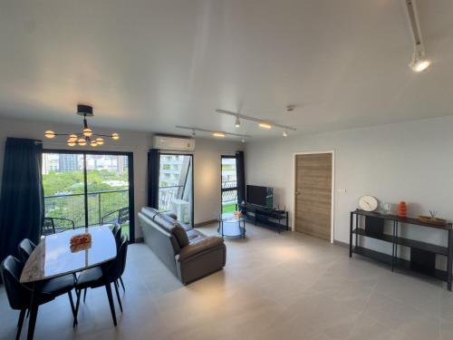 a living room with a couch and a table at Nice view over the heart of Bangkok in Bangkok