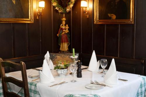 a table in a restaurant with a white table cloth at Hotel Gasthaus Adler in Glottertal