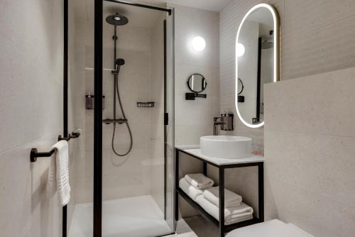 a bathroom with a sink and a shower at TRIBE Krakow Old Town in Kraków
