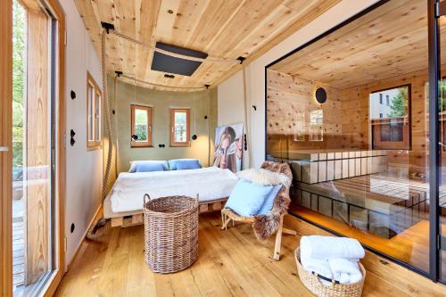 a bedroom in a house with a bed and a tub at City Suites Murnau in Murnau am Staffelsee