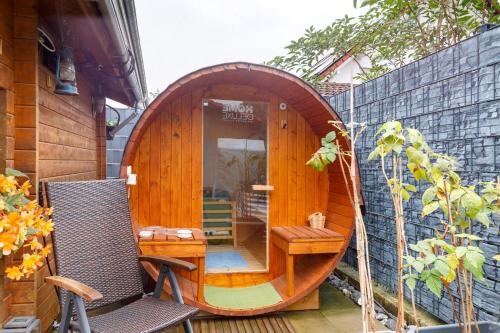 a small wooden sauna with a wooden circle on a building at Ferienwohnung am Rosenberg in Stockach