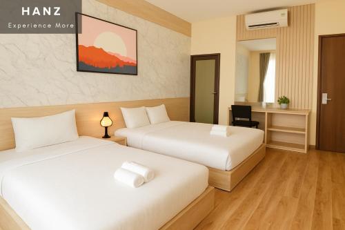 a hotel room with two beds and a desk at S79 PowerMia RiverFront Grand World in Phu Quoc