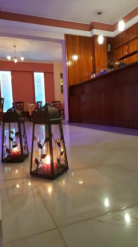 two lights on the floor of a room with a table at Hermes in Agia Marina Aegina