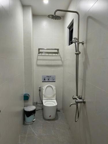 a small bathroom with a toilet and a shower at New Pearl Hotel HCM in Ho Chi Minh City