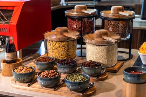 a group of jars filled with different types of nuts at TRIBE Krakow Old Town in Kraków
