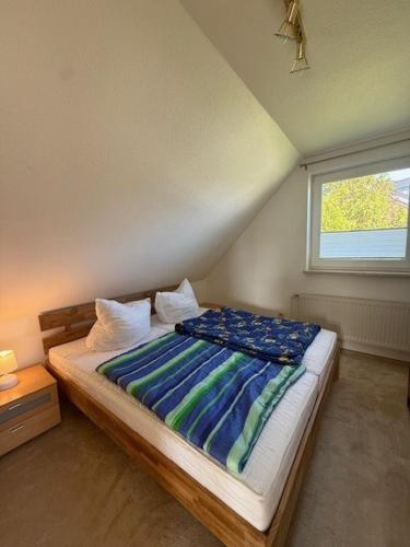 a bed in a room with a window at Nordstern 3 in Dahme