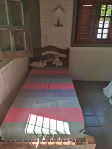 a bed in a room with a rug on the floor at Casa de praia em Itamaracá próxima à praia in Itamaracá